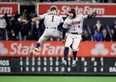 Astros' Carlos Correa (left) and George Springer celebrate their team's 8-3 win over the New York Yankees in Game 4 of the American League Championship Series at Yankee Stadium on Oct. 17, 2019 in New York City. (GETTY IMAGES)