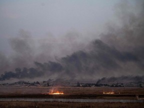 Smoke rises from the Syrian town of Tal Abyad, in a picture taken from the Turkish side of the border near Akcakale, on Thursday, Oct. 10, 2019, on the second day of Turkey's military operation against Kurdish forces.
