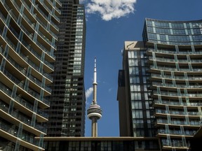 The CN Tower is framed by condo buildings off of Fort York Blvd., west of Spadina Ave. in Toronto on Aug. 28, 2019.