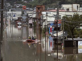 Police officers search an area by boat that was flooded by Typhoon Hagibis on October 14, 2019 in Marumori, Miyagi, Japan. (Tomohiro Ohsumi/Getty Images)