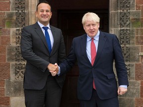 Ireland's Taoiseach Leo Varadkar (left) and Britain's Prime Minister Boris Johnson pose for a photograph outside Thornton Manor Hotel, England on October 10, 2019, as they meet for Brexit talks. (NOEL MULLEN/POOL/AFP via Getty Images)