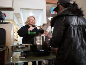 Actress and animal rights activist Pamela Anderson serves free vegan meals during an event held by Green Party candidate for East Vancouver Bridget Burns to register voters for the federal election, in the downtown Eastside of Vancouver, on Wednesday October 9, 2019.