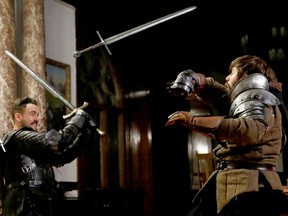 Staff members practice sword fighting before a role play event at the Moszna Castle in Moszna, Poland Oct. 10, 2019.