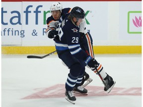 Edmonton Oilers defenceman Ethan Bear (left) steps into Winnipeg Jets forward Patrik Laine during NHL action in Winnipeg on Sun., Oct. 20, 2019.