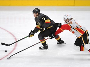 Vegas Golden Knights left wing Valentin Zykov (7) skates through the stick check of Calgary Flames defenceman Noah Hanifin (55) at T-Mobile Arena. (Stephen R. Sylvanie-USA TODAY Sports)