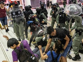 A riot police uses pepper spray as they attempt to make arrest in a shopping mall during a rally on November 3, 2019 in Hong Kong, China.