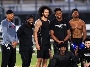 Colin Kaepernick, centre, stands with Bruce Ellington, Brice Butler, Jordan Veasy, and Ari Werts during the Colin Kaepernick NFL workout held at Charles R. Drew High School on Nov. 16, 2019 in Riverdale, Ga. (Carmen Mandato/Getty Images)