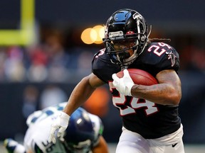 Devonta Freeman of the Atlanta Falcons rushes against the Seattle Seahawks at Mercedes-Benz Stadium on October 27, 2019 in Atlanta, Georgia.