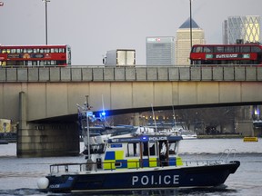 Boats from the Metropolitan Police Marine Policing Unit patrol near the scene after a number of people are believed to have been injured after a stabbing at London Bridge, police have said, on November 29, 2019 in London, England.
