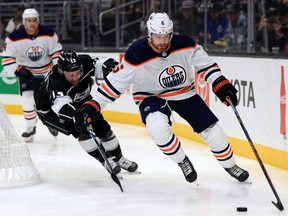 Kyle Clifford of the Los Angeles Kings chases Adam Larsson of the Edmonton Oilers during the second period of a game at Staples Center on Nov. 21, 2019 in Los Angeles.