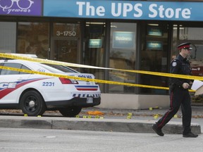Toronto Police investigating a murder on Nov. 4 are pictured at a plaza on North Queen St. and The Queensway.