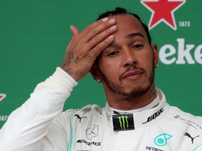 Mercedes' Lewis Hamilton on the podium after finishing in third place before a penalty resulted in him being demoted to seventh at the Brazilian Grand Prix  in Sao Paulo, Brazil, Nov. 17, 2019. (REUTERS/Ricardo Moraes)