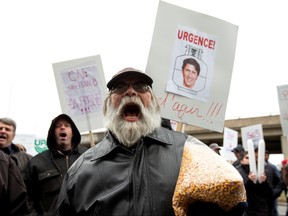 Farmers carrying corn grain protest in front of the Papineau riding office of Prime Minister Justin Trudeau, due to the Canadian National Railway (CN Rail) strike, Nov. 25, 2019.  (REUTERS/Christinne Muschi)