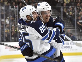 Jets' Mathieu Perreault and Gabriel Bourque celebrate Perreault's goal against the Golden Knights during the first period on Saturday night in Vegas.