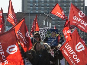 Striking Unifor members walk along Broad Street during a march past a number of Crown Corporation buildings in downtown Regina in October.