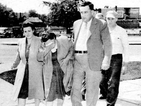 Elizabeth Popovich, centre, is led into court. She and her husband were hanged for a 1946 Thorold murder.