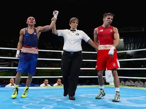Vladimir Nikitin of Russia celebrates his victory over Michael John Conlan of Ireland in the boxing  Men's Bantam Quarterfinal 1 on Day 11 of the Rio 2016 Olympic Games at Riocentro on August 16, 2016 in Rio de Janeiro, Brazil.