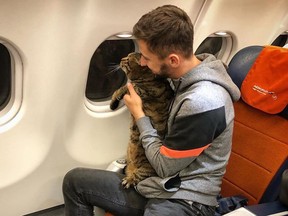 Mikhail Galin claims he lost airline miles because he snuck his fat cat on board a plane by swapping him for a slimmer cat. (Facebook)
