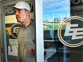 Eskimos quarterback Trevor Harris opens a door with the Commonwealth Stadium field reflected off the glass, on his way to speak to the media after their season ended in the Eastern Finals Sunday losing to Hamilton, in Edmonton, November 18, 2019.