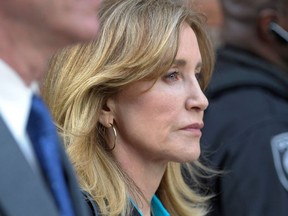 In this file photo taken on April 3, 2019, actress Felicity Huffman exits the courthouse after facing charges for allegedly conspiring to commit mail fraud and other charges in the college admissions scandal at the John Joseph Moakley United States Courthouse in Boston.