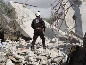 A Mmeber of the Syrian Civil Defence (White Helmets) takes part in a search for victims of a Russian airstrike that hit the village of Jaballa in the south of the Idlib region on November 2, 2019.
