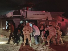 Handout picture released by the Health Secretary of Sonora state press office showing Medical personnel of the Health Secretary and of the Mexican Air Force transfering five members of the Lebaron family after being injured during an gunmen ambush in the limits of Sonora and Chihuahua in Hermosillo, Mexico, on November 5, 2019.