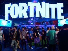 In this file photo taken on June 12, 2018, people crowd the display area for the survival game Fortnite at the 24th Electronic Expo, or E3 2018, in Los Angeles, California.