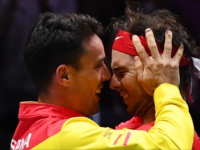 Spain's Rafael Nadal, right, celebrates with Spain's Roberto Bautista Agut after defeating Canada's Denis Shapovalov during the final singles tennis match between Canada and Spain at the Davis Cup Madrid Finals 2019 in Madrid on Nov. 24, 2019. (GABRIEL BOUYS/AFP via Getty Images)