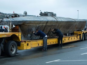 Official stand near a submarine used to transport drugs illegally in Aldan, northwestern Spain, on Nov. 27, 2019. (LALO R. VILLAR/AFP via Getty Images)