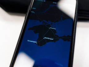 An illustration picture taken on November 28, 2019 in Moscow shows an Apple map with the Crimea peninsula on a smartphone screen.