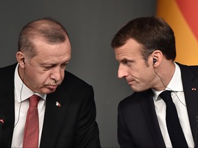 In this file photo taken on Oct. 27, 2018, Turkish President Recep Tayyip Erdogan, left, and President Emmanuel Macron attend a conference as part of a summit called to attempt to find a lasting political solution to the civil war in Syria which has claimed in excess of 350 000 lives, at Vahdettin Mansion in Istanbul. (OZAN KOSE/AFP via Getty Images)