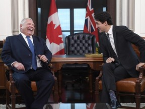 Prime Minister Justin Trudeau and Ontario Premier Doug Ford share a laugh after Ford spoke in French during a meeting in Ottawa on Friday, Nov. 22, 2019.