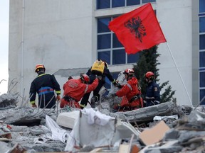 Emergency personnel put an Albanian flag on top of rubble, on the occasion of the Albanian Independence Day, during a search for survivors in a collapsed building in Durres, after an earthquake shook Albania, November 28, 2019. REUTERS/Florion Goga REFILE - ADDING INFORMATION ORG XMIT: GDN521