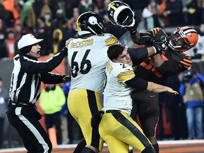 Cleveland Browns defensive end Myles Garrett hits Pittsburgh Steelers quarterback Mason Rudolphwith his own helmet as offensive guard David DeCastro tries to stop Garrett during the fourth quarter at FirstEnergy Stadium in Cleveland, Ohio, on Nov. 14, 2019.