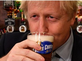 Britain's Prime Minister Boris Johnson sips a pint of beer at the Lynch Gate Tavern in Wolverhampton, Britain, November 11, 2019.