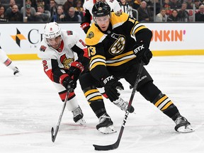Boston Bruins centre Charlie Coyle (13) controls the puck in front of Ottawa Senators defenceman Dylan DeMelo at the TD Garden. (Brian Fluharty-USA TODAY Sports)
