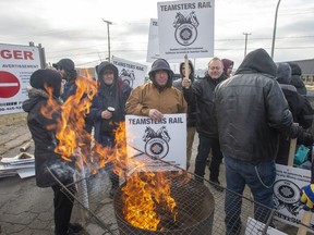 Striking Canadian National Railway workers picket in front of the company's Taschereau railyard Friday, Nov. 22, 2019 in Montreal. (THE CANADIAN PRESS/Ryan Remiorz)