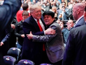 U.S. President Donald Trump is greeted by former boxer Roberto Duran as he arrives to watch a mixed martial arts fight in Madison Square Garden in New York City, on Saturday, Nov. 2, 2019.