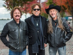 The Doobie Brothers — Tom Johnston (from left), John McFee and Pat Simmons — pose for a photo in downtown Toronto on Thursday Oct. 30, 2014.