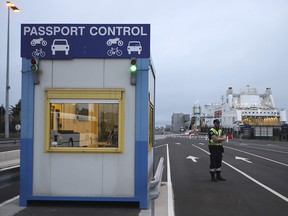 French custom officers work at the transit zone while a ferry coming from Britain's port of Portsmouth docks at the port of Ouistreham, Normandy, Thursday, Sept.12, 2019. (AP Photo/David Vincent)