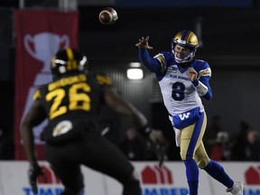 Winnipeg Blue Bombers quarterback Zach Collaros throws a pass as Hamilton Tiger-Cats defensive back Cariel Brooks defends in the first half during the 107th Grey Cup championship football game at McMahon Stadium. Mandatory Credit: Eric Bolte-USA TODAY Sports ORG XMIT: USATSI-408191