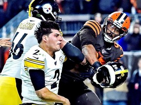 Cleveland Browns defensive end Myles Garrett hits Pittsburgh Steelers quarterback Mason Rudolph with his own helmet as offensive guard David DeCastro tries to stop Garrett during the fourth quarter at FirstEnergy Stadium.