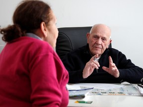 French doctor Christian Chenay, 98, treats a patient in his consulting room in Chevilly-Larue near Paris, France, Nov.20, 2019.