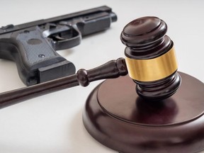 Gavel in front of a pistol.