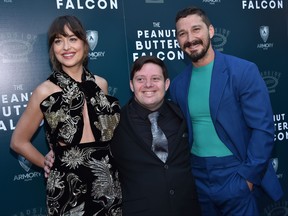 Actors Dakota Johnson, left, Zack Gottsagen, centre, and Shia LaBeouf arrive for the screening of "The Peanut Butter Falcon" at the Arclight theatre in Hollywood on August 1, 2019. (CHRIS DELMAS/AFP via Getty Images)