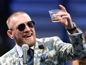 Conor McGregor holds up a cup of his Notorious-branded Irish whiskey as he speaks during a news conference following his 10th-round TKO loss to Floyd Mayweather Jr. in their super welterweight boxing match at T-Mobile Arena on August 26, 2017 in Las Vegas, Nevada.  (Ethan Miller/Getty Images)