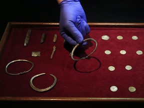 A close up of some of the jewellery and ingots of a significant hoard found near Watlington, in Oxfordshire, England as they are displayed at the British Museum in London, Thursday, Dec. 10, 2015. (AP Photo/Alastair Grant)