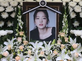 The portrait of late K-pop star Goo Hara is seen surrounded by flowers at a memorial altar at a hospital in Seoul on Monday, Nov. 25, 2019.