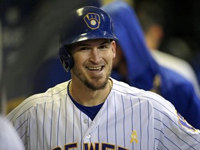 In this Sept. 7, 2019, file photo, Milwaukee Brewers' Yasmani Grandal smiles in the dugout after hitting a home run against the Chicago Cubs, in Milwaukee.  (AP Photo/Aaron Gash, File)