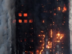 In this June 14, 2017, file photo, flames and smoke engulf Grenfell Tower, in north Kensington, West London, England.